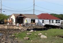 38 & 40 Old Mill Rd undergoing careful demolition. Debris had to be cut up using hand tools and carried off site to an awaiting dump truck, since the properties were inaccessible to heavy equipment. Photo credit: Town of Westport.